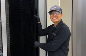 Andy Jo holding a solar module