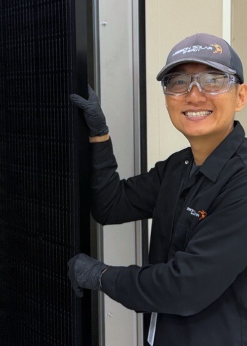 Andy Jo holding a solar module