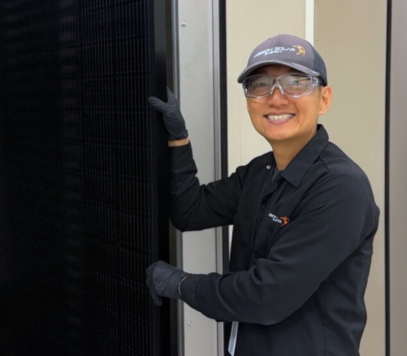 Andy Jo holding a solar module