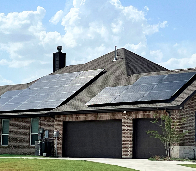 Residential solar panels on top of a home roof.